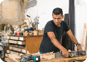 Work: Latin American worker in his workshop using different tools.